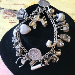 Silver Charm Bracelet with Chunky Chain and Playful Elements